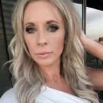 Lexi wearing a white top taking a selfie