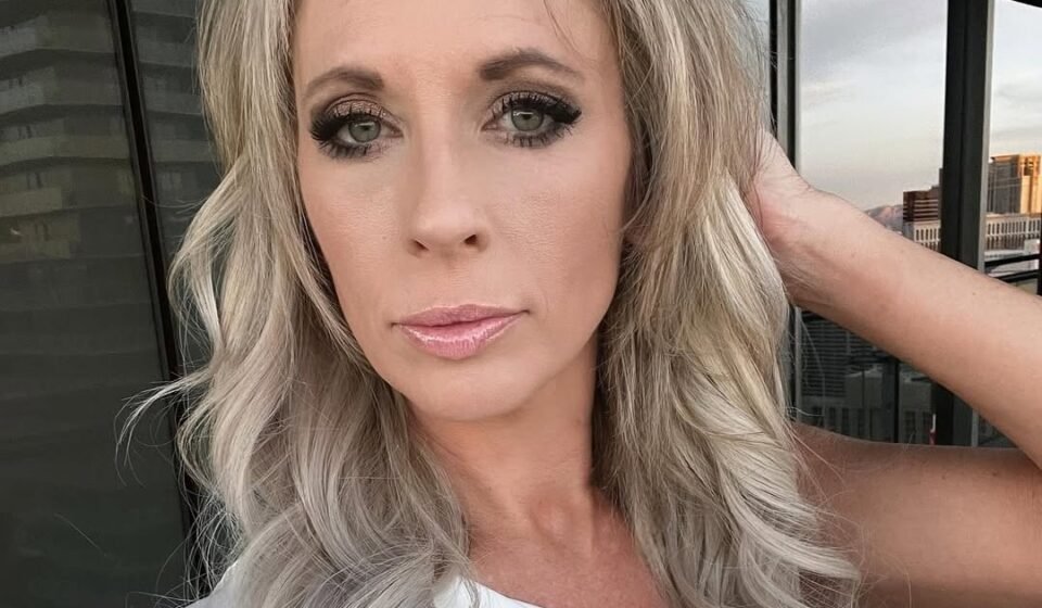 Lexi wearing a white top taking a selfie